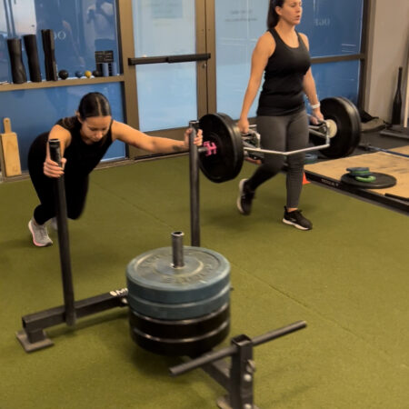 Members using the prowler sled and trap bar