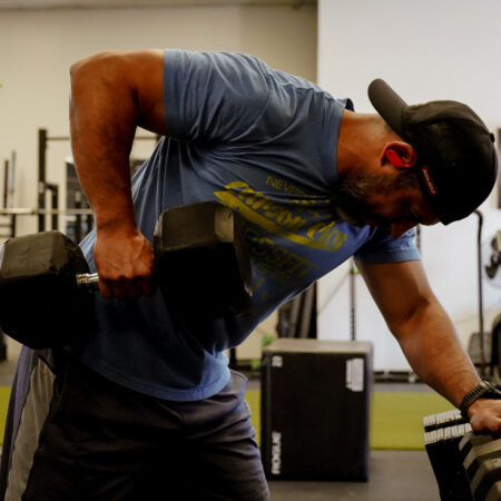 Member performing dumbbell rows