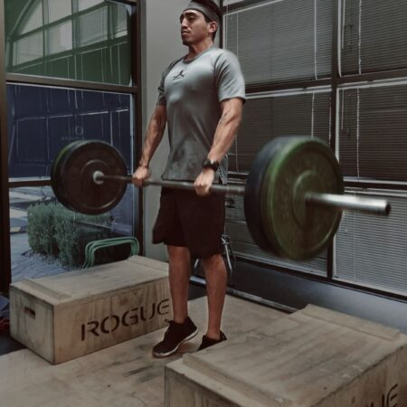 Member deadlifting with a Rogue barbell setup